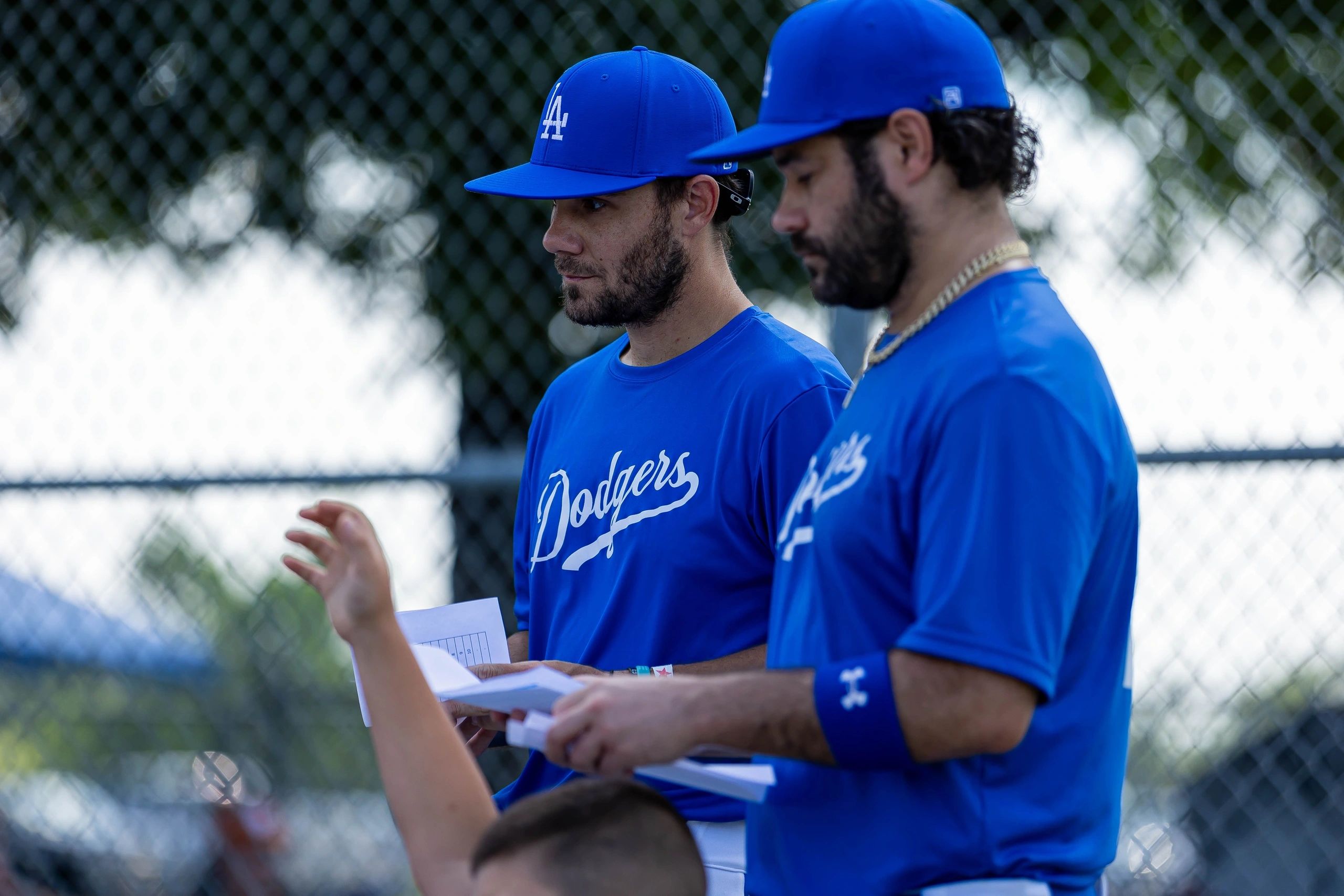 Matt Young and his brother Mike coaching at Young Brothers Academy, talking with a young player