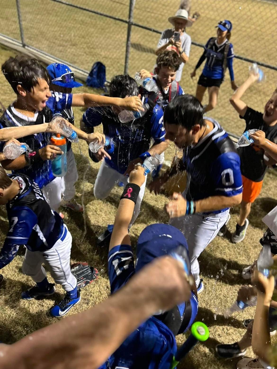 Dodgers players soaking Coach Matt with water bottles after a win