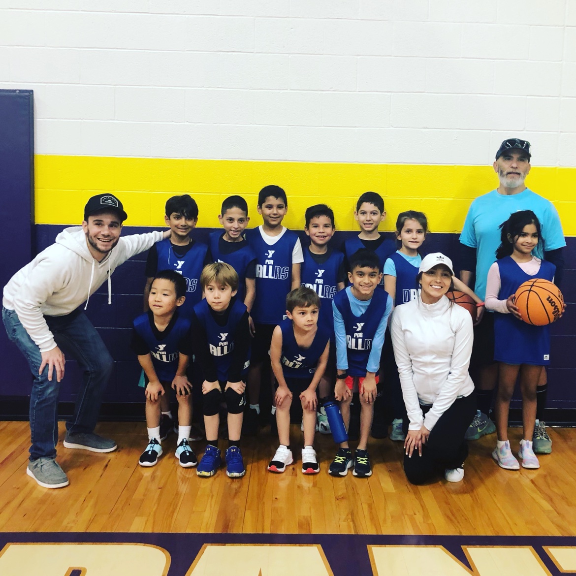 Matt Young with a youth basketball team in the gym