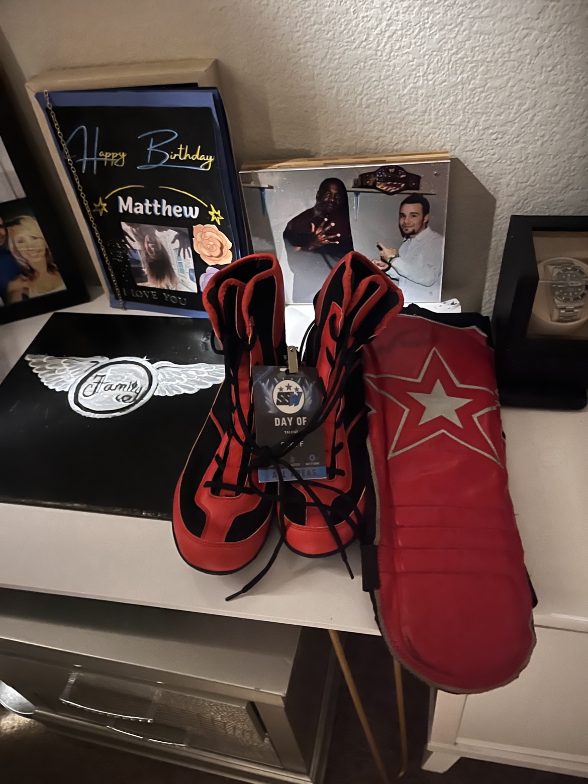 Red boots and wrestling gear laid out